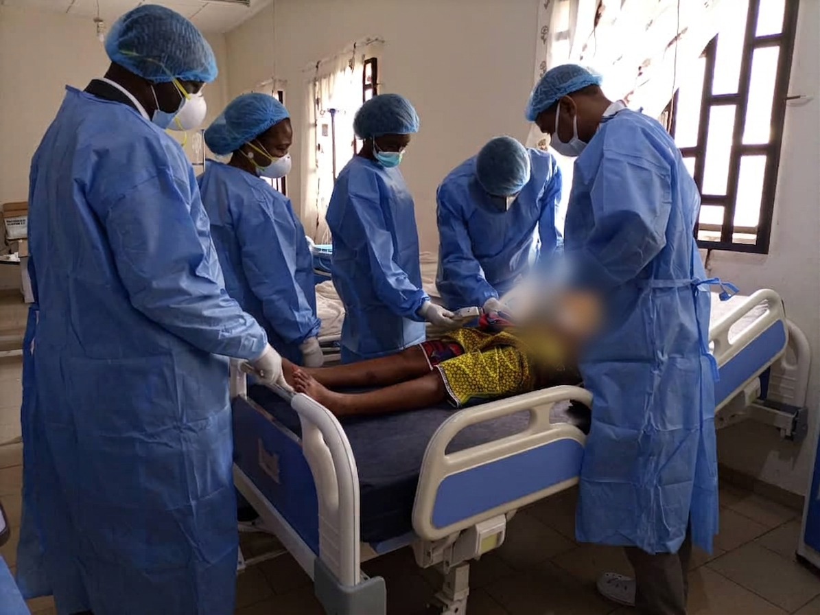 Multidisciplinary clinical team attending to a patient in isolation